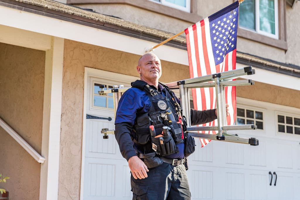 Trident inspector climbing a ladder for a residential roof inspection